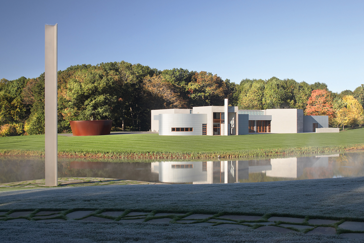 View of a museum gallery's exterior with two sculptures outside.