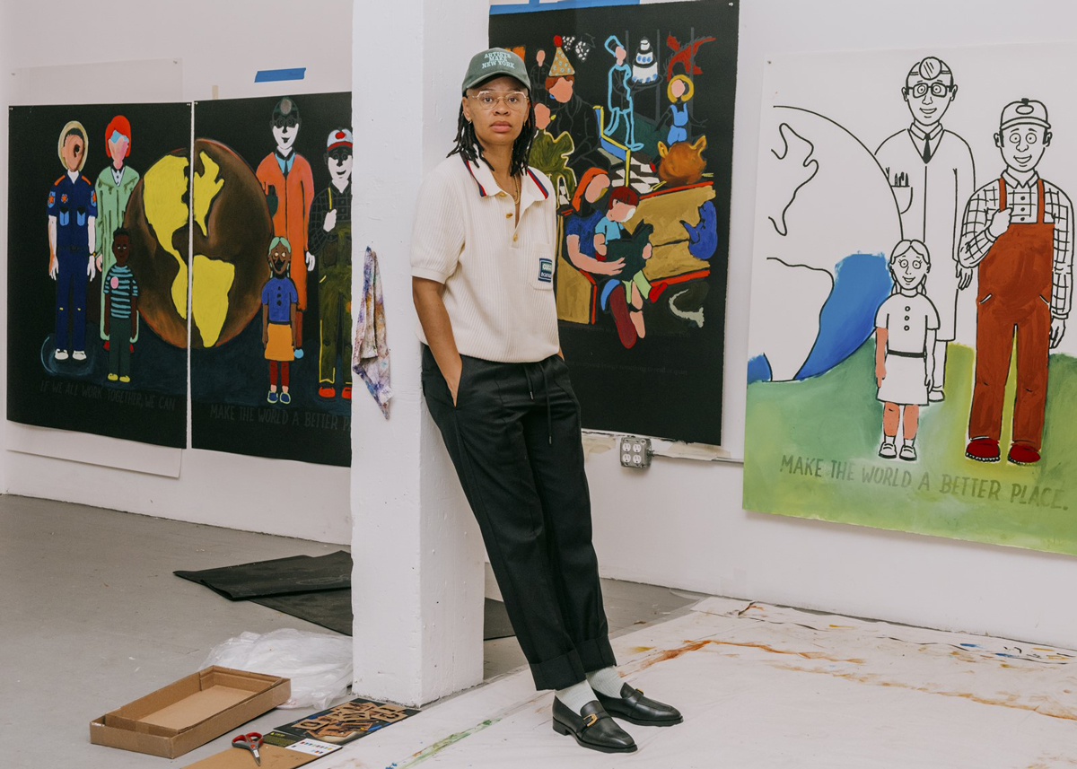 Portrait of Sable Elyse Smith, leaning against a pillar with artworks hanging on the wall behind.